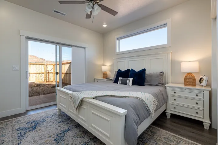 Bedroom with access to outside, dark wood finished floors, ceiling fan, and recessed lighting