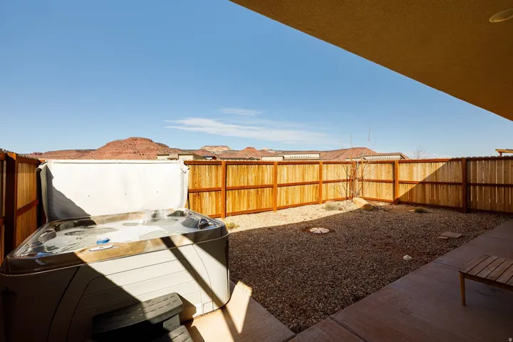 Fenced backyard with a patio