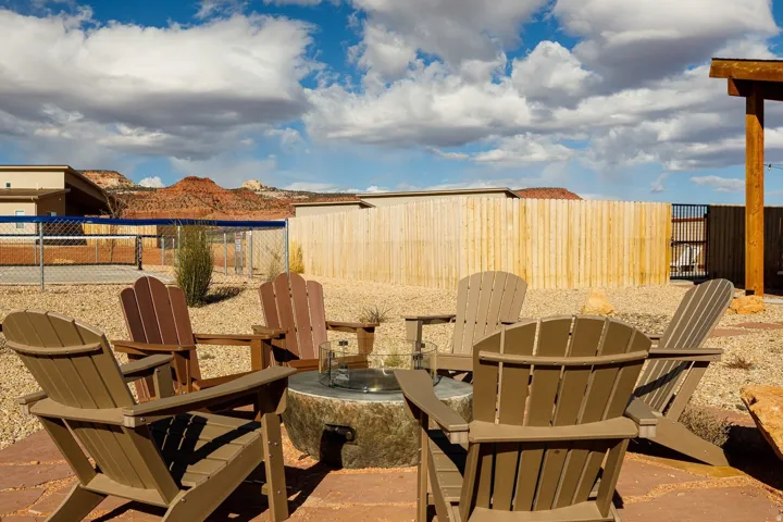 Fenced backyard featuring an outdoor fire pit and a patio area