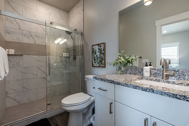 Bathroom with vanity and a stall shower