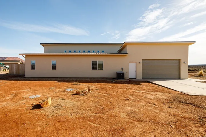View of front of property featuring stucco siding, driveway, and a garage