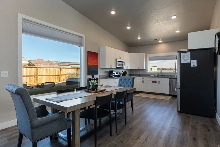 Dining area featuring lofted ceiling, dark wood finished floors, and recessed lighting