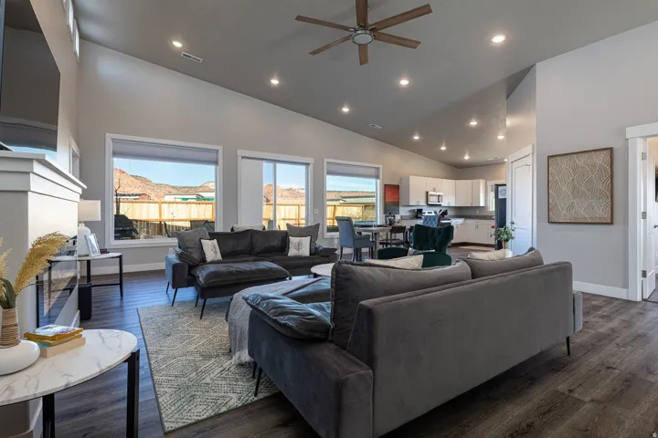 Living room featuring a ceiling fan, dark wood-type flooring, recessed lighting, and lofted ceiling