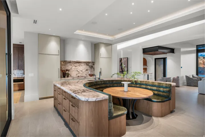 Kitchen featuring modern cabinets, light stone countertops, tasteful backsplash, recessed lighting, and open floor plan