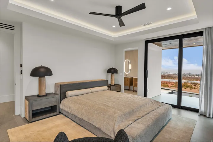 Bedroom featuring access to outside, a raised ceiling, recessed lighting, expansive windows, and a ceiling fan