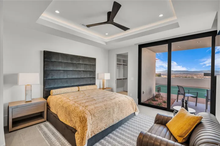 Bedroom with floor to ceiling windows, a walk in closet, a ceiling fan, access to exterior, and recessed lighting
