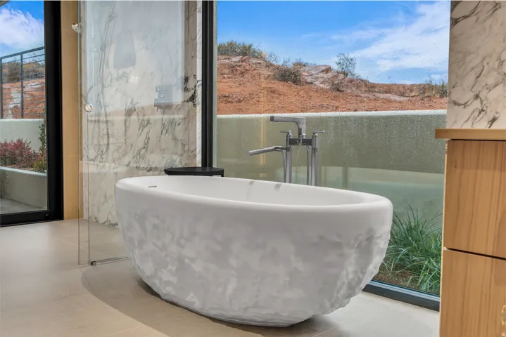 Bathroom with healthy amount of natural light and a freestanding bath