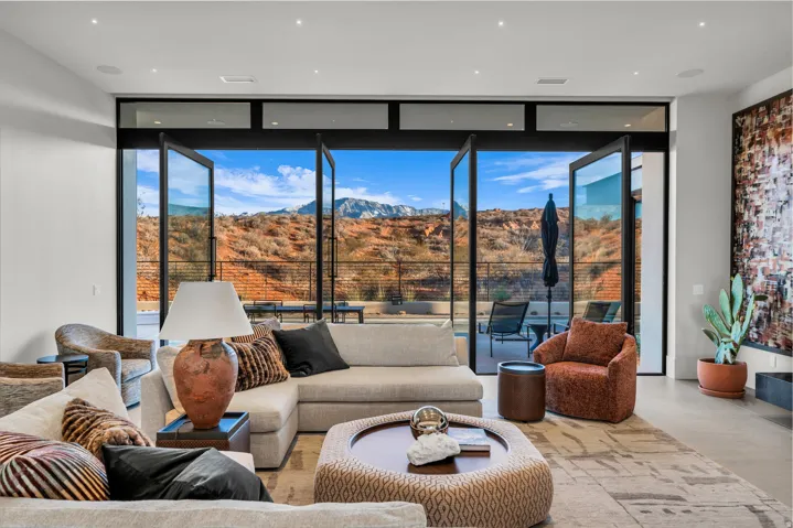 Living room featuring floor to ceiling windows, a mountain view, and concrete flooring