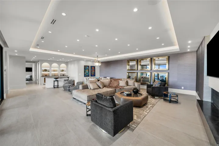 Living room featuring a tray ceiling and recessed lighting