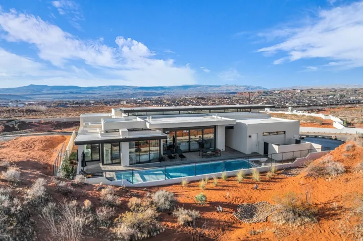 Rear view of property featuring a mountain view, a patio area, and stucco siding