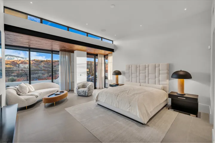 Bedroom with expansive windows and access to outside