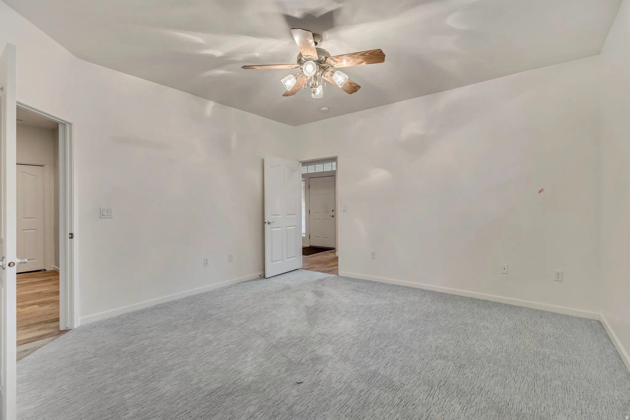 Unfurnished bedroom with carpet and ceiling fan