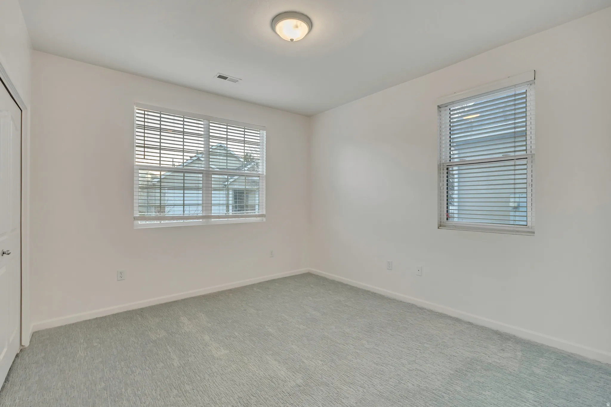 Unfurnished bedroom with a closet and light colored carpet
