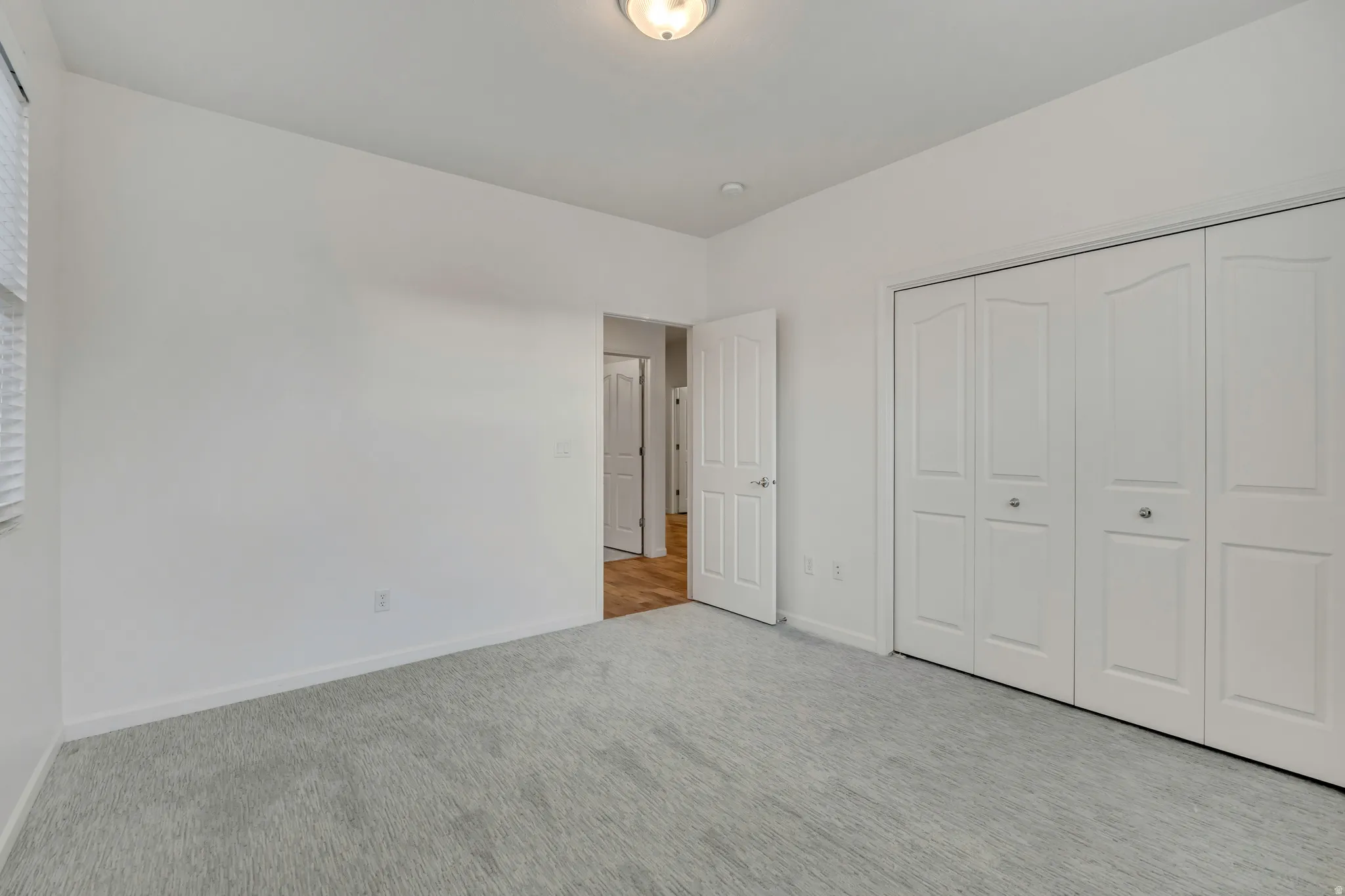 Unfurnished bedroom with carpet flooring and a closet