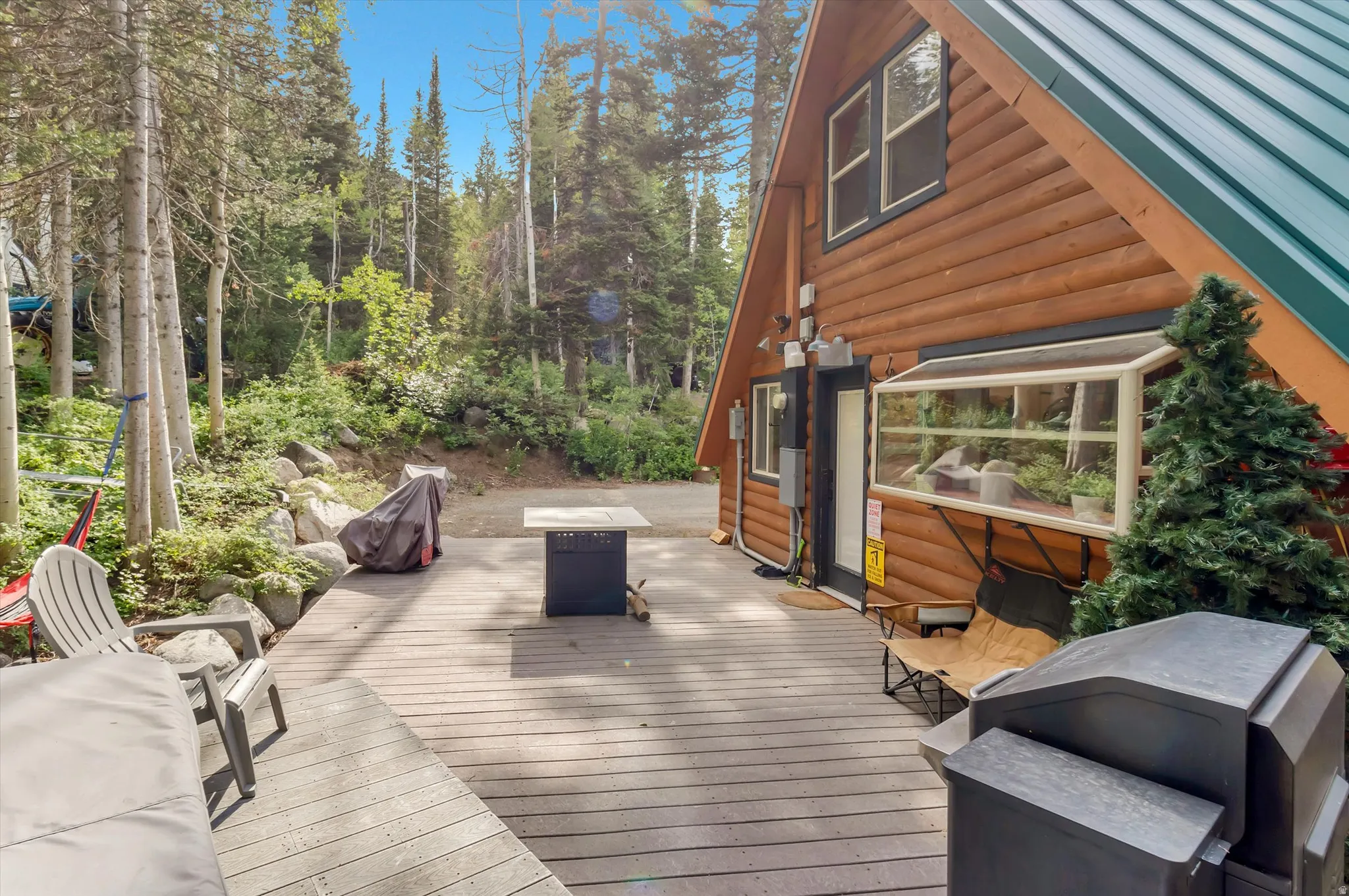 Expansive wood-finish deck with a log-sided A-frame structure