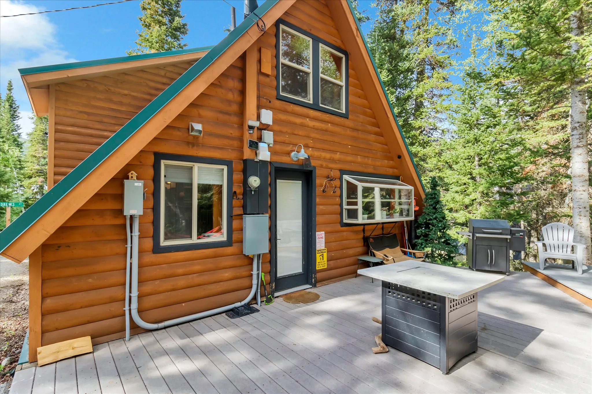 A-frame log cabin exterior with a composite deck