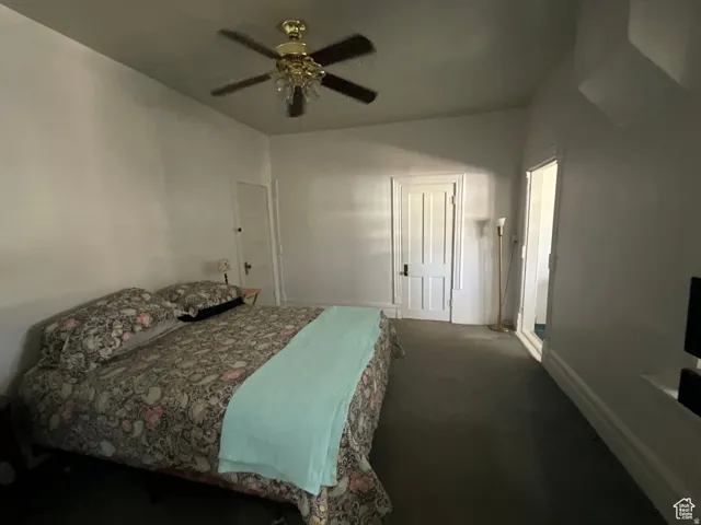 Bedroom featuring carpet floors, ceiling fan, and a closet