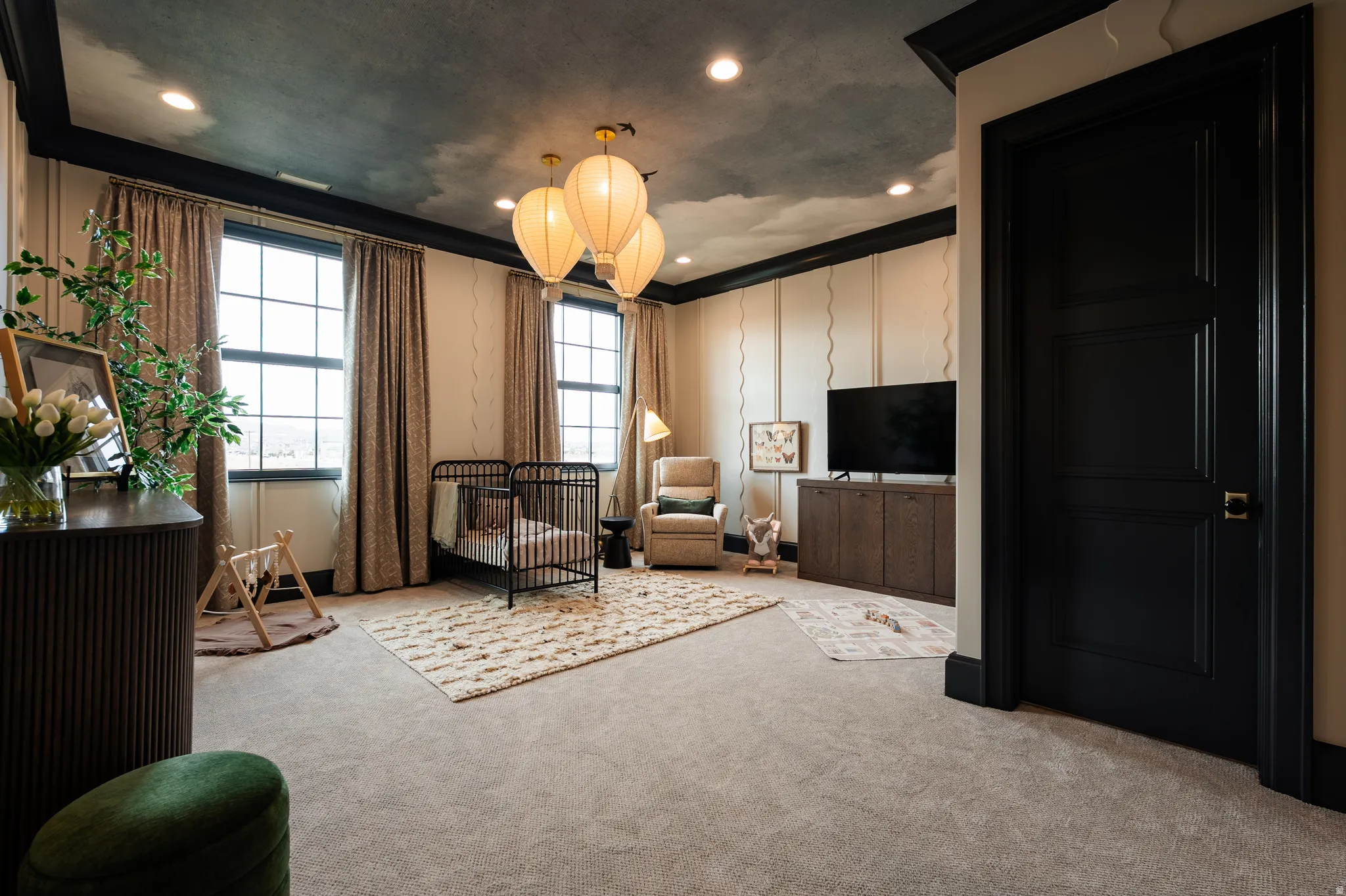Living area with crown molding, carpet floors, and a chandelier