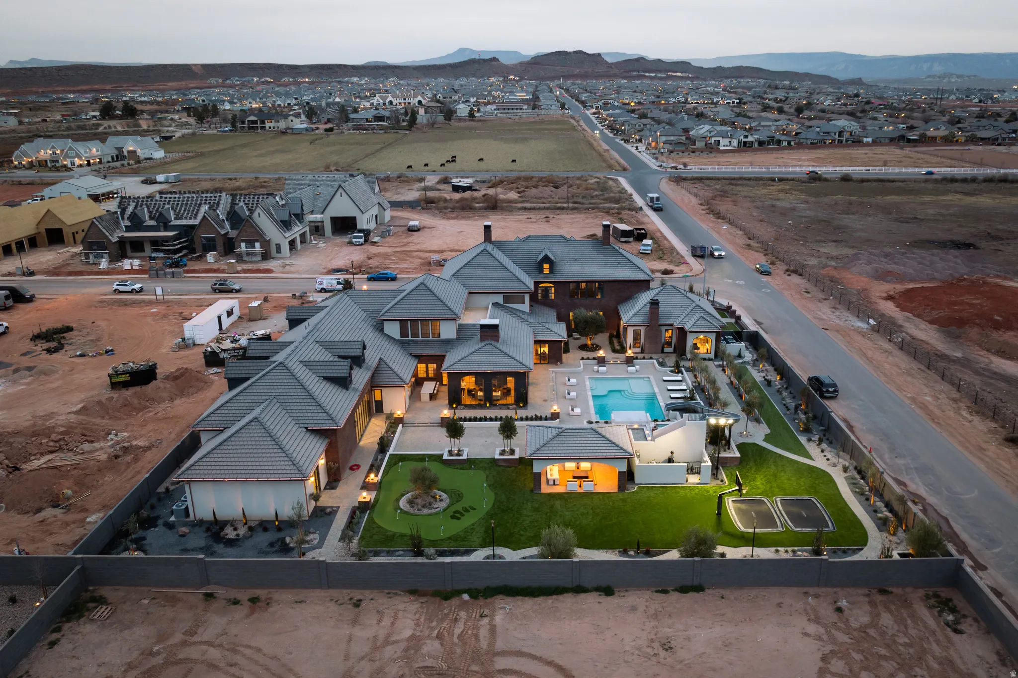 Aerial view of residential area featuring a mountainous background and a pool area