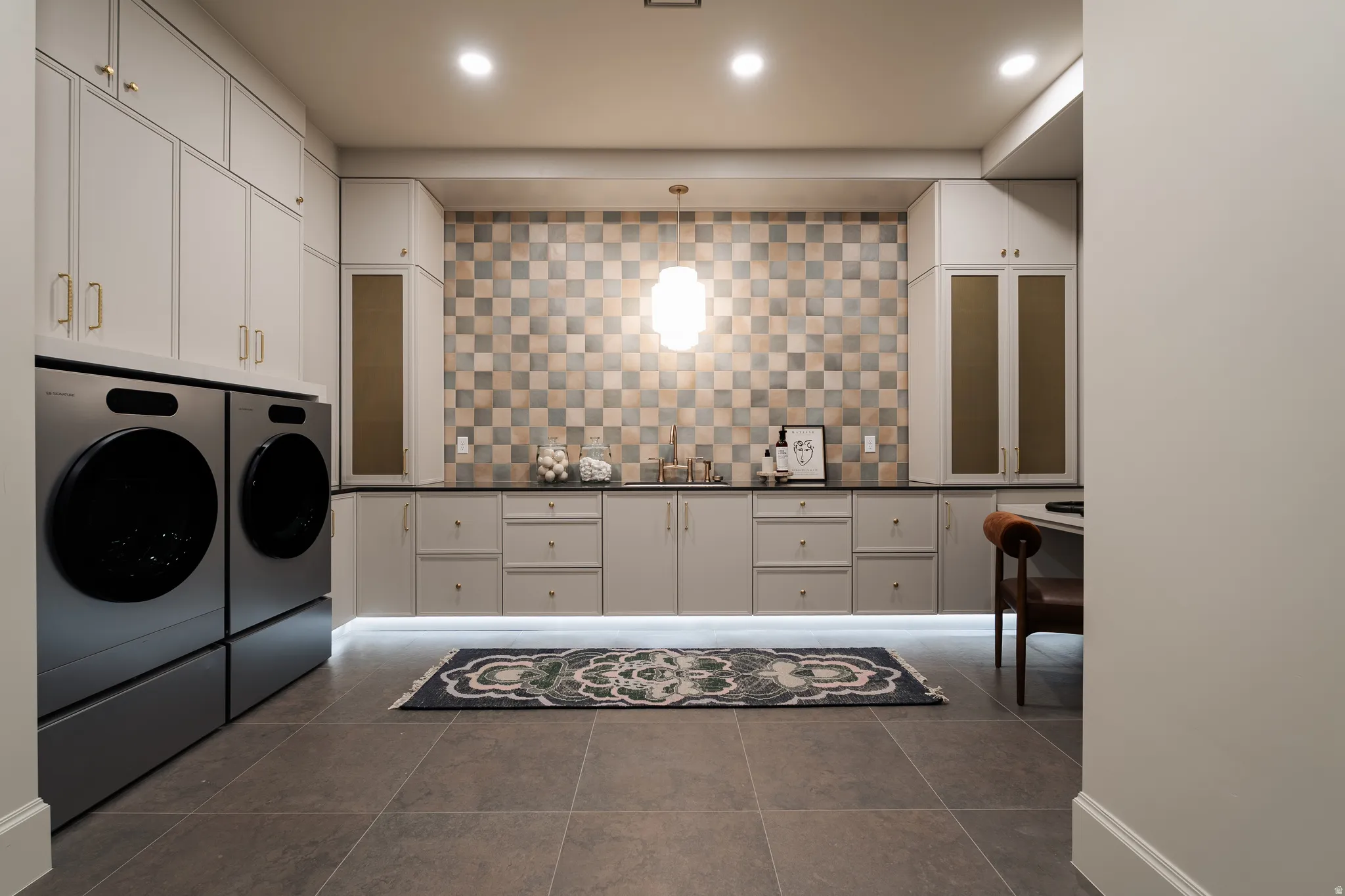 Laundry area featuring washer and clothes dryer, cabinet space, and recessed lighting
