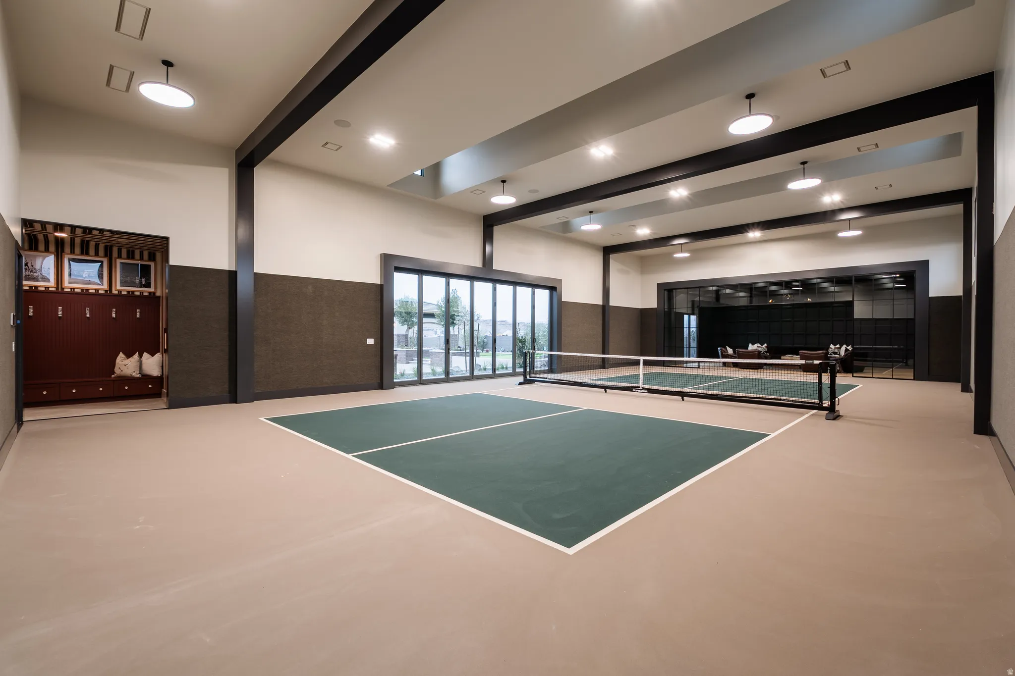 View of tennis court featuring a patio area