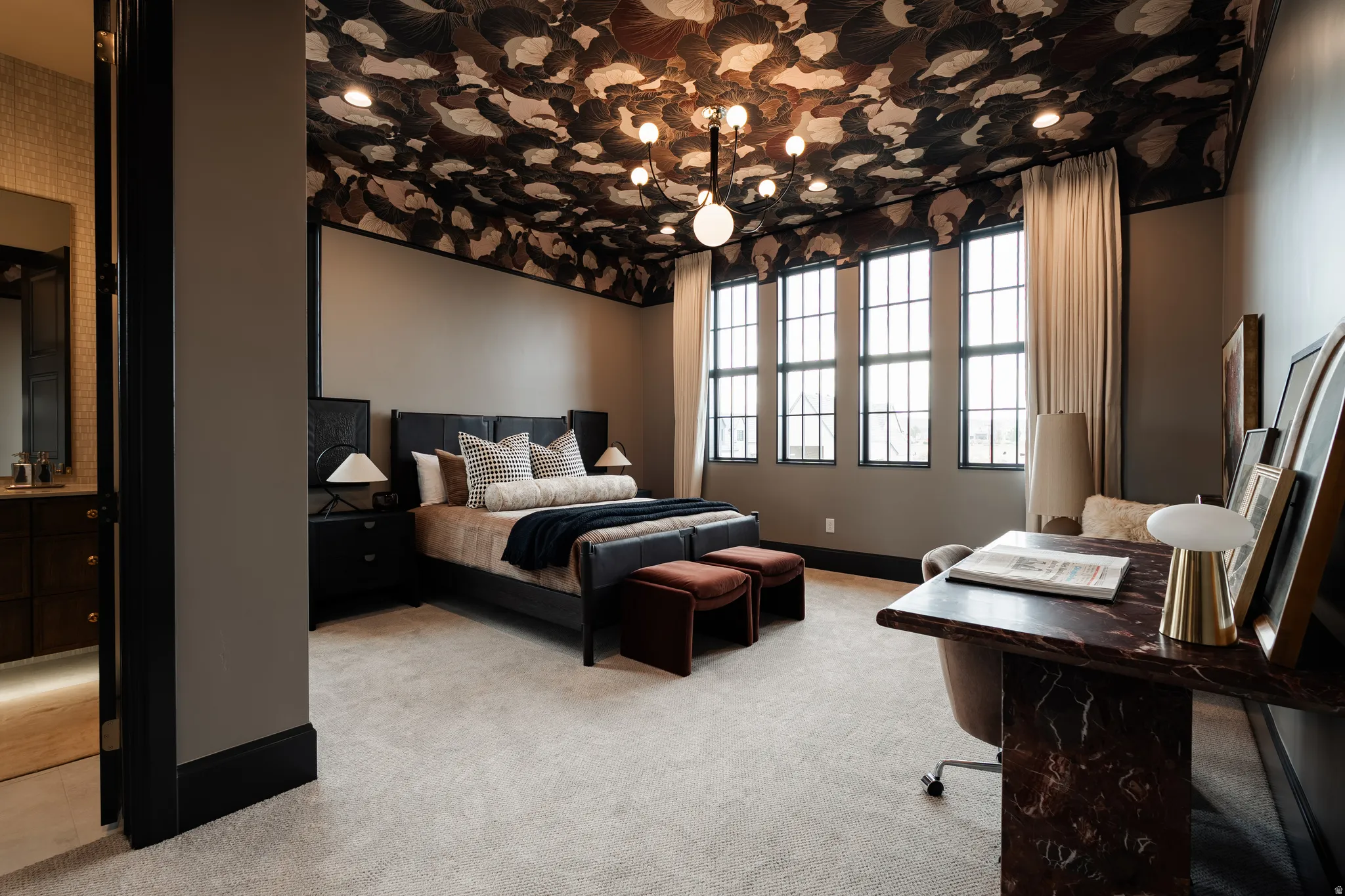 Bedroom featuring light colored carpet and hanging lights