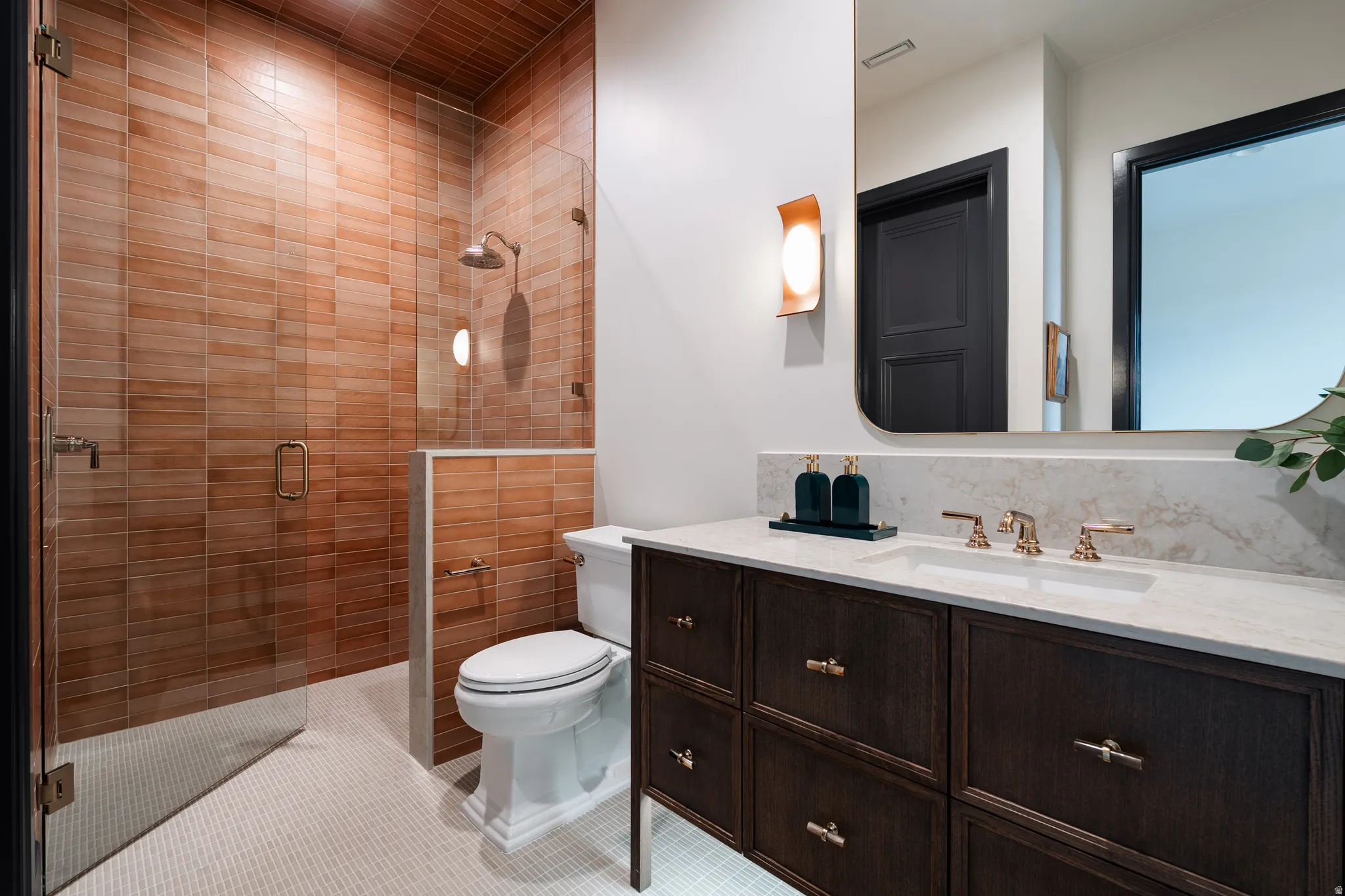 Bathroom with a shower stall and vanity