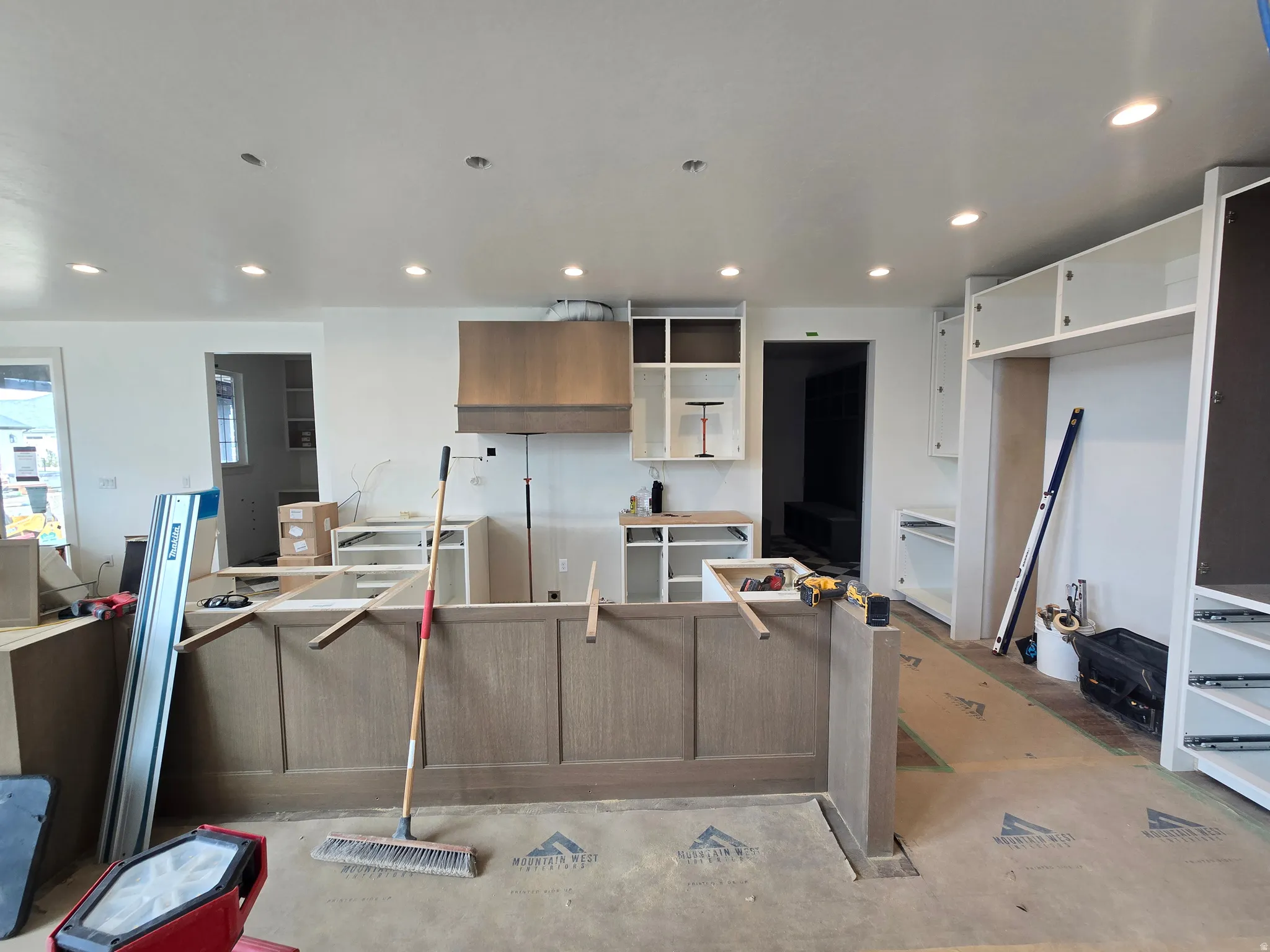 Kitchen with a large island, recessed lighting, dual tone cabinets, modern cabinets, and open shelves