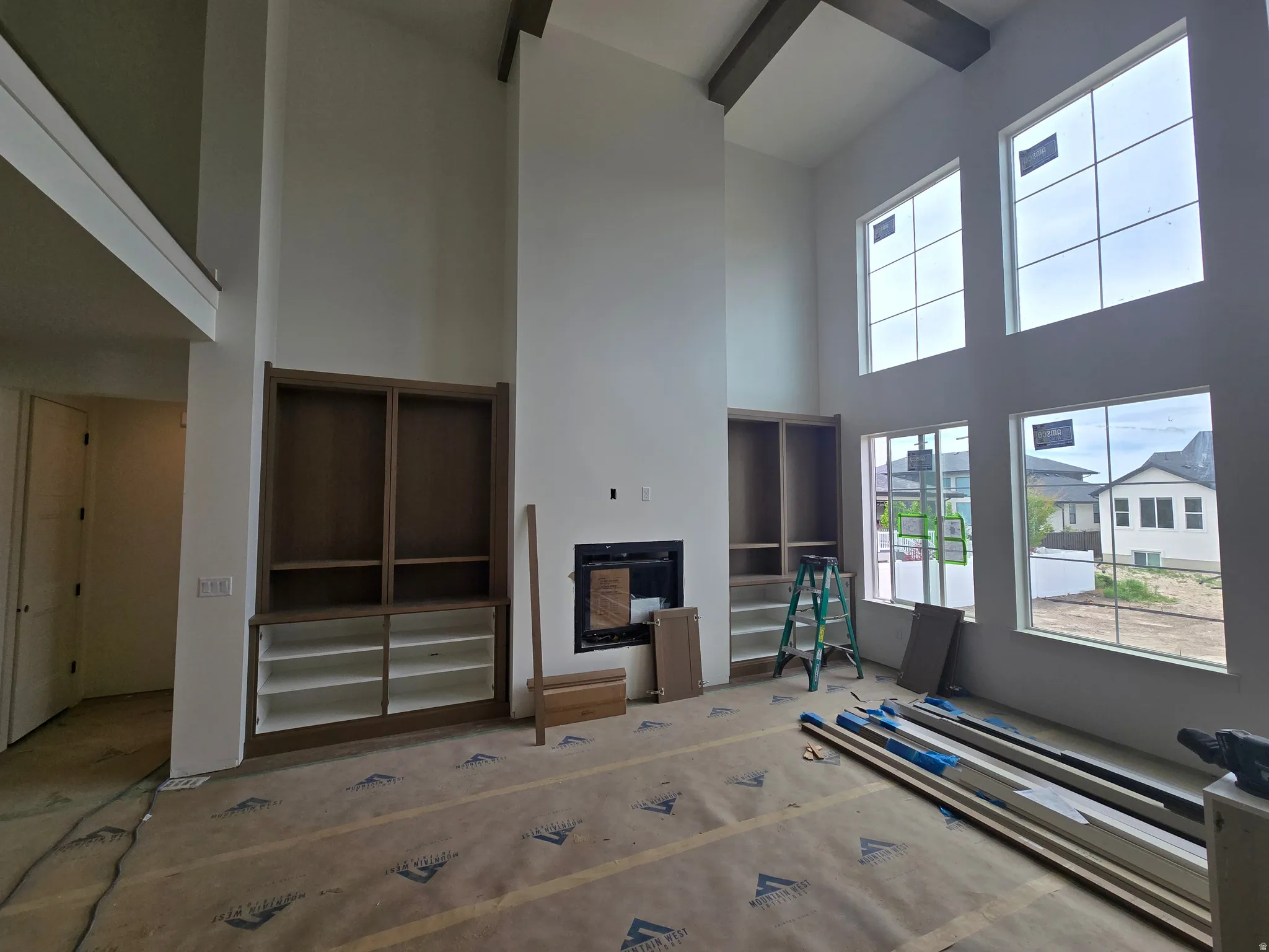 Living area with a fireplace and a high ceiling