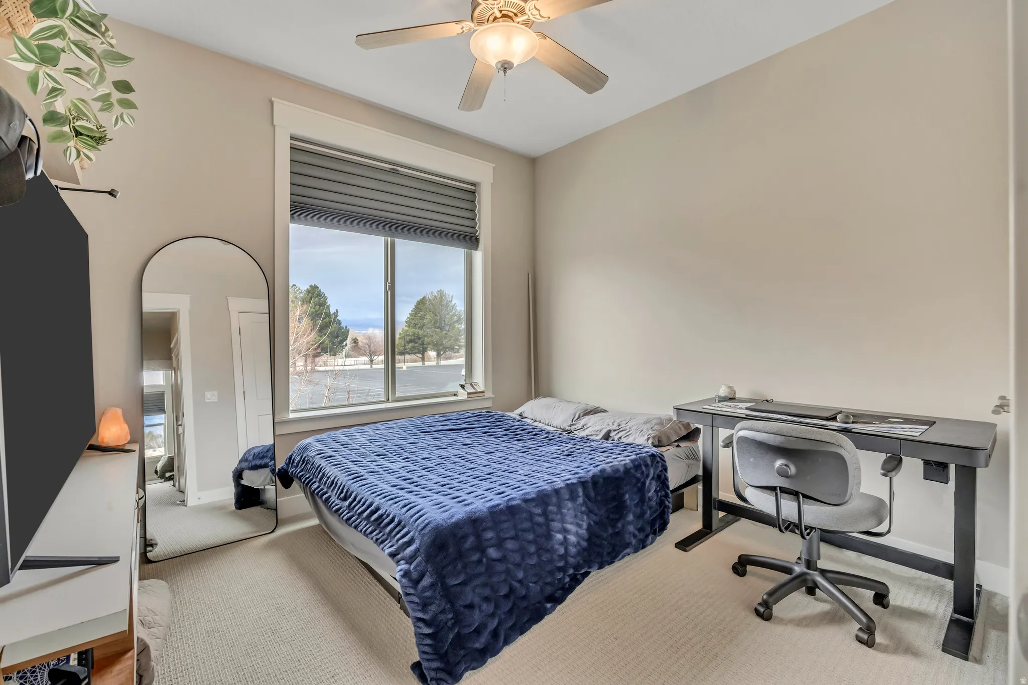 Bedroom featuring a ceiling fan and carpet flooring