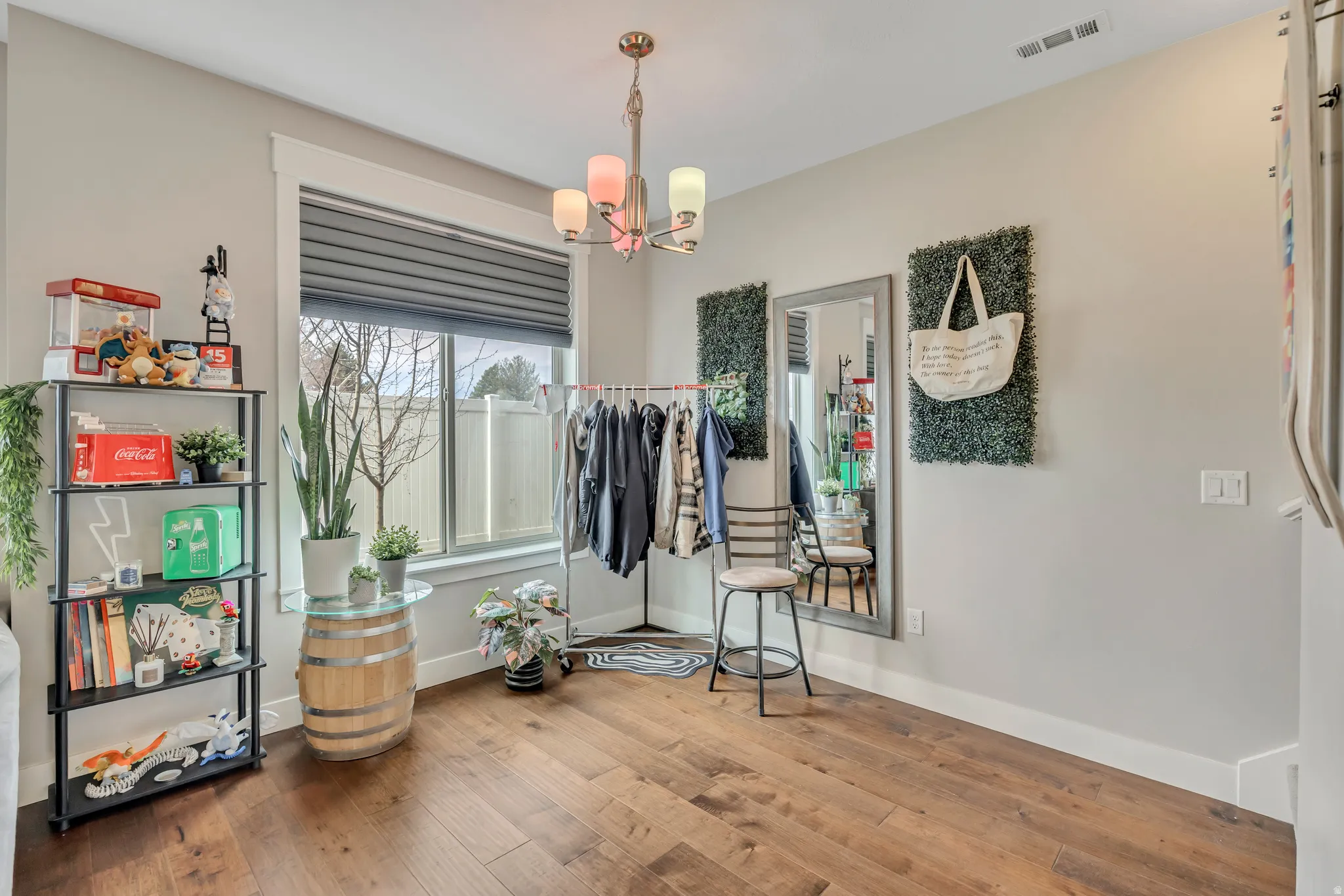 Dining area featuring hardwood / wood-style flooring and suspended lighting