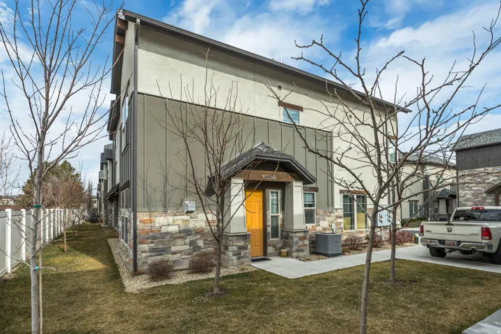 View of front of property featuring stone siding and stucco siding