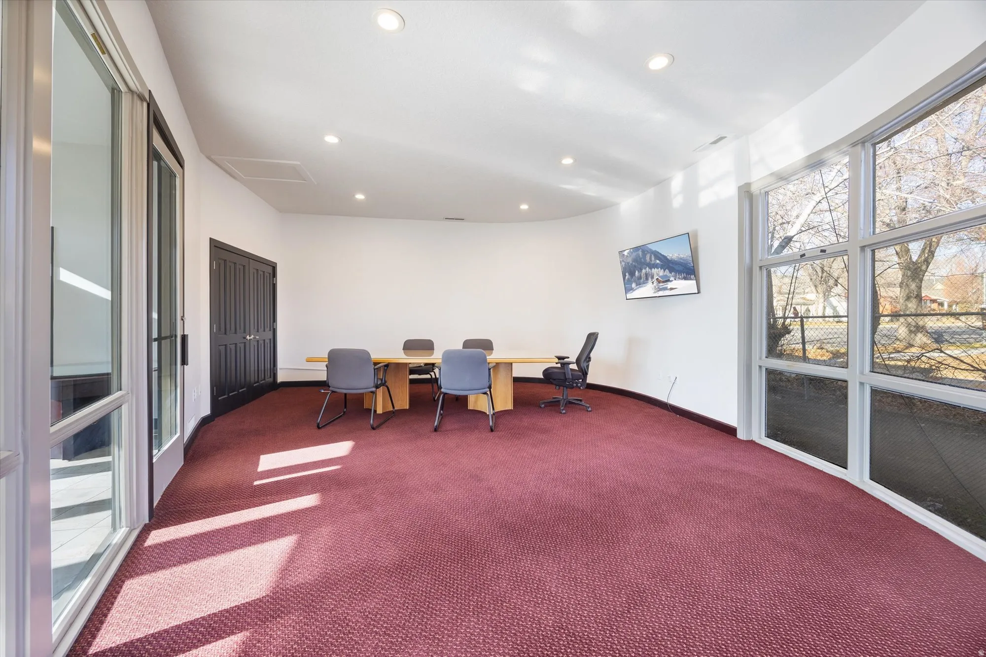 Living area with carpet, recessed lighting, and an office area