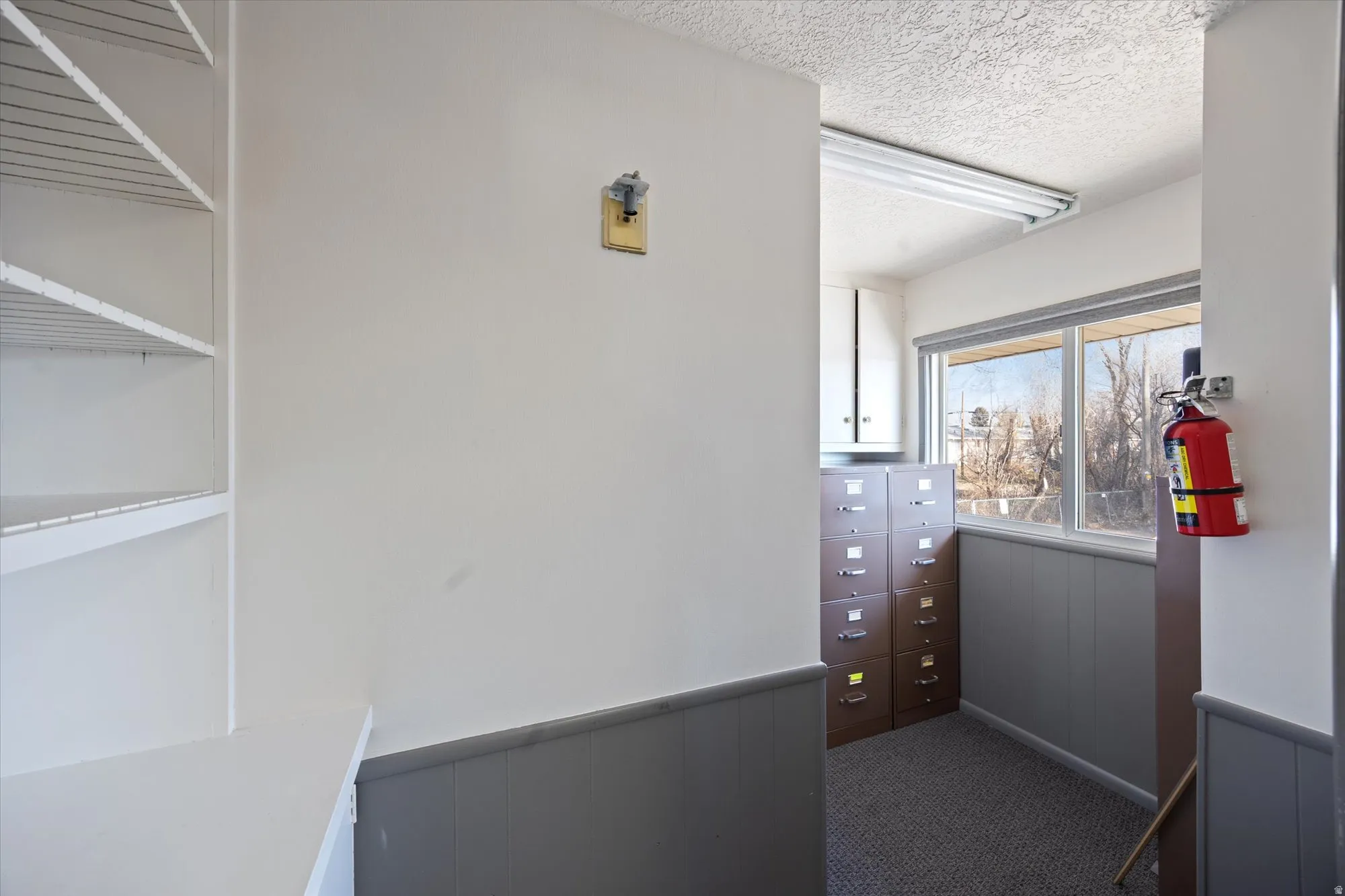 Walk in closet featuring dark carpet