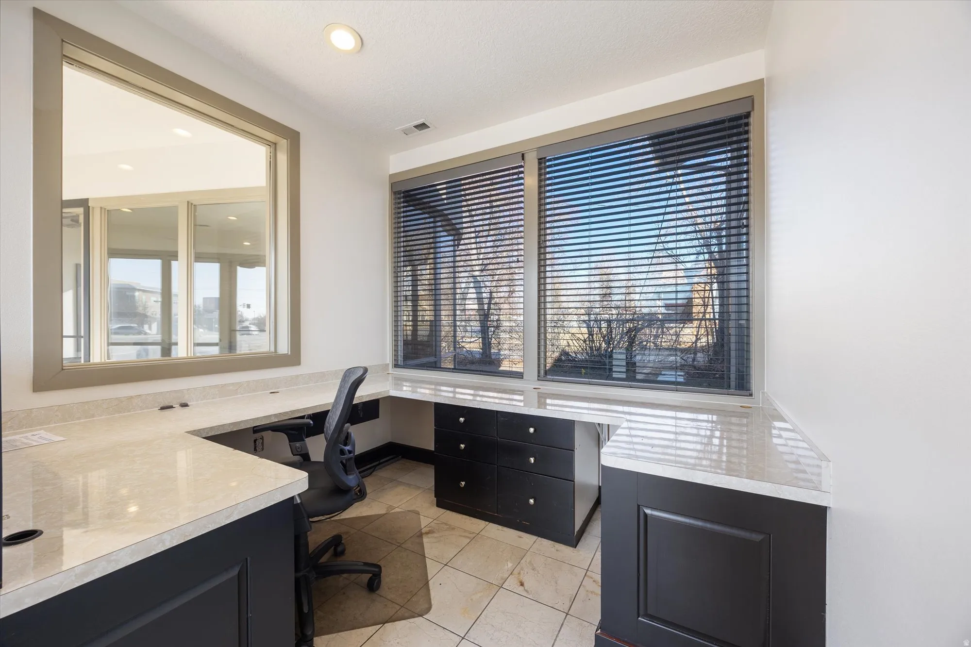 Office area with built in desk and healthy amount of natural light