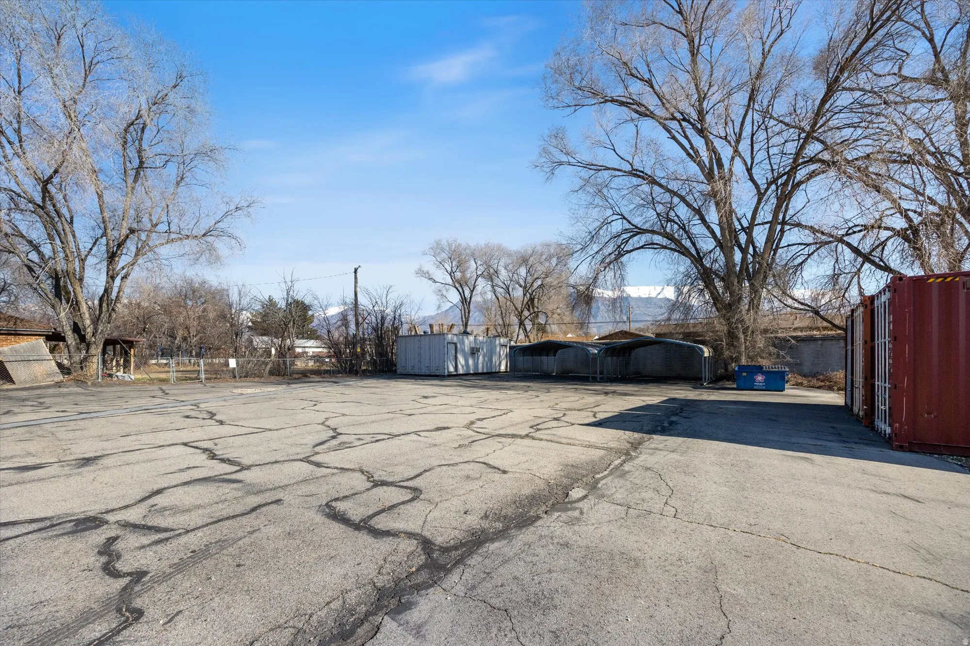 View of parking featuring a detached carport