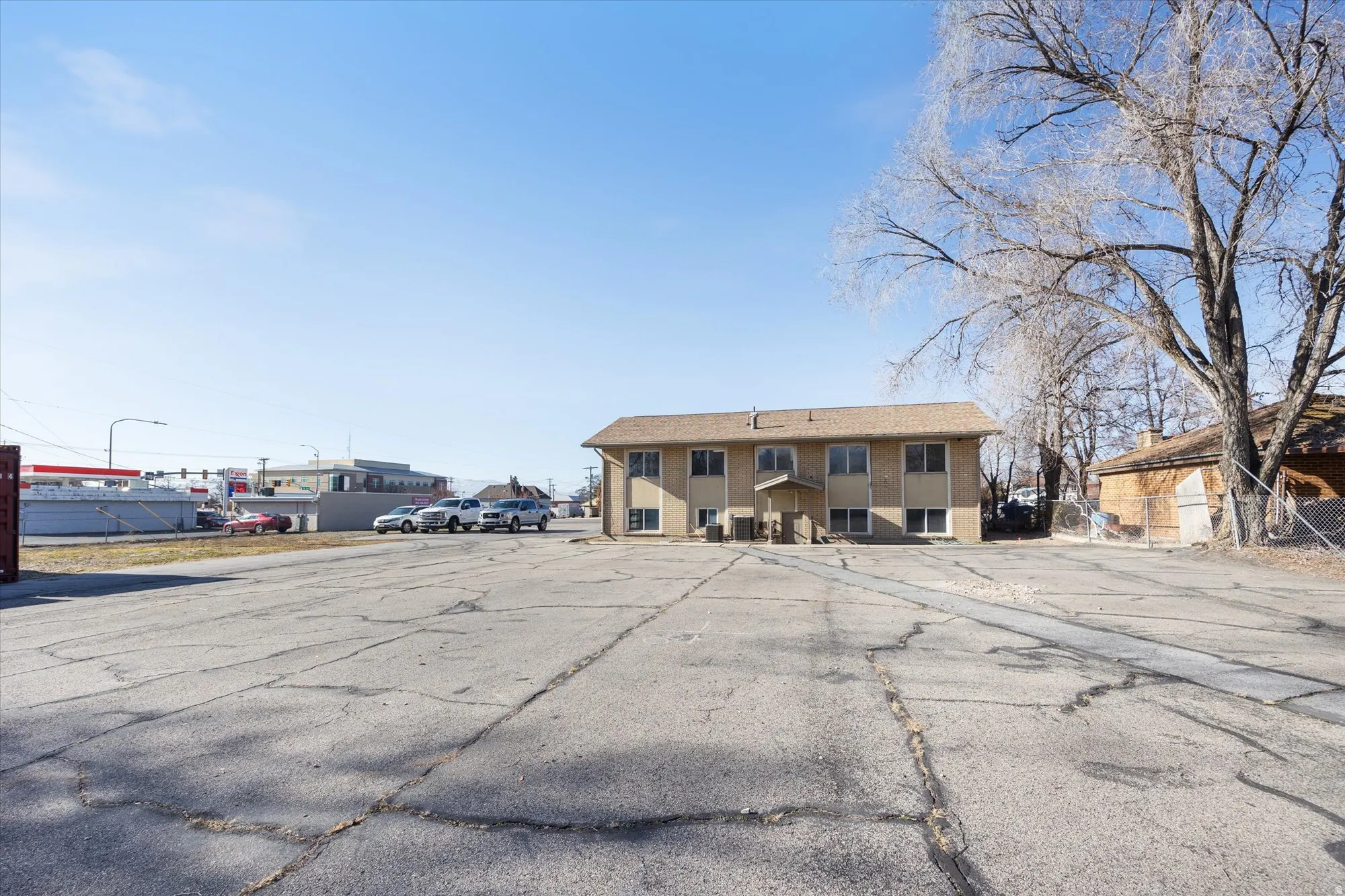 View of building exterior featuring uncovered parking