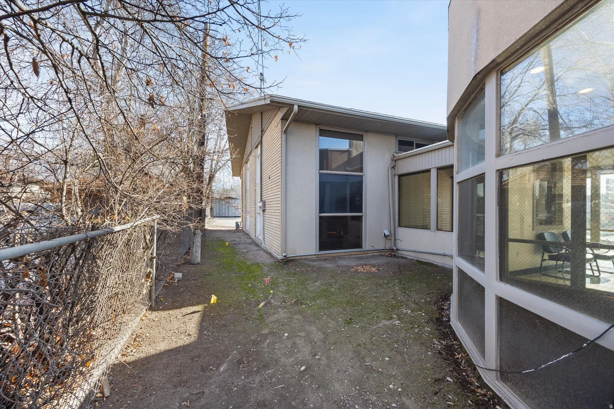 View of side of property with a sunroom