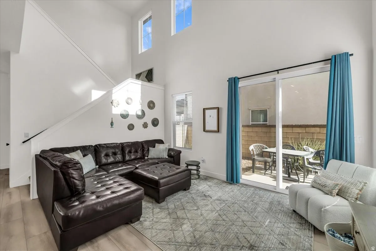 Living room featuring a high ceiling and light wood finished floors