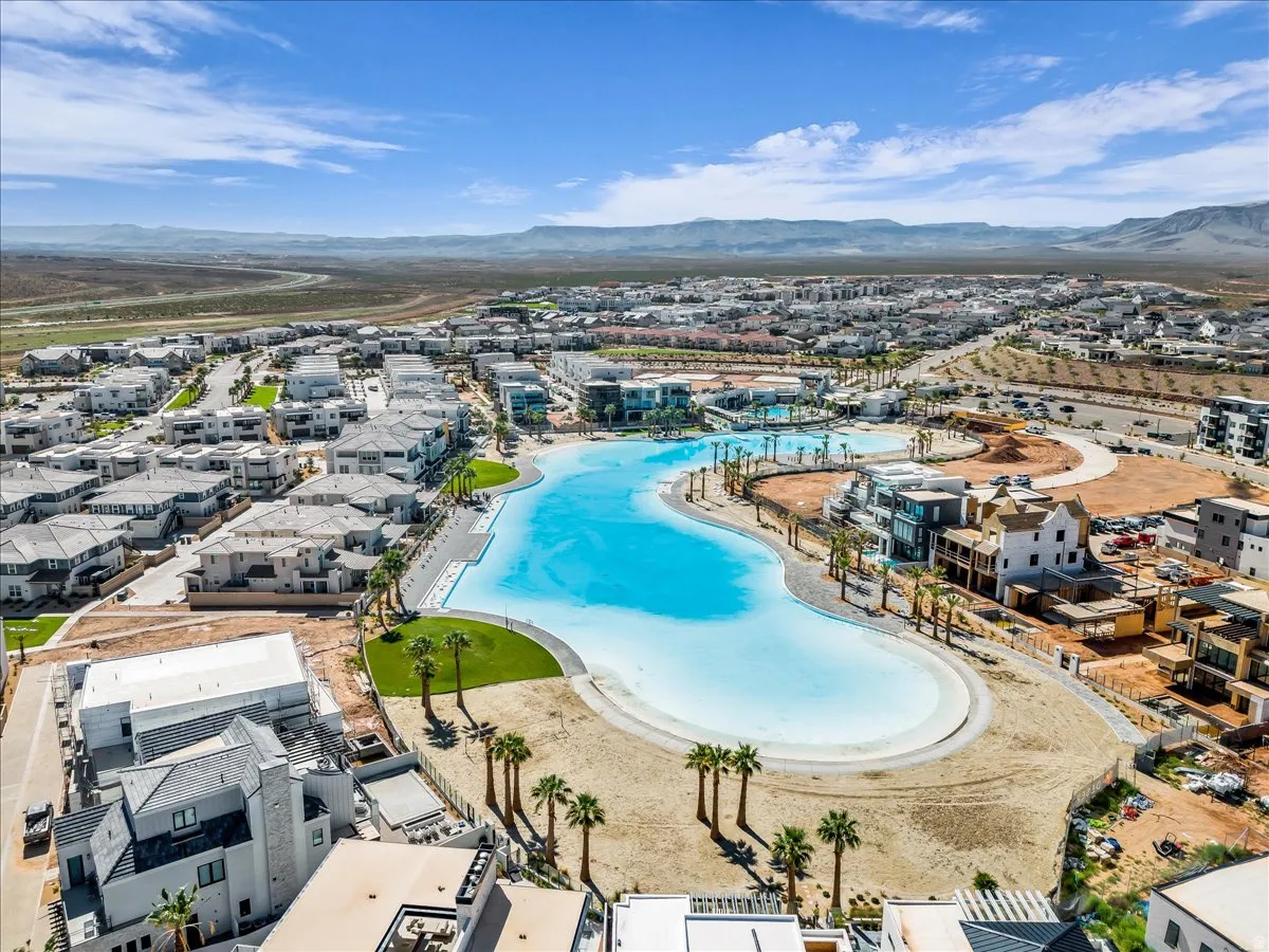Aerial view of residential area with a mountainous background and a pool area