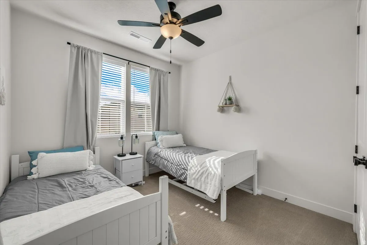 Bedroom with carpet flooring and ceiling fan