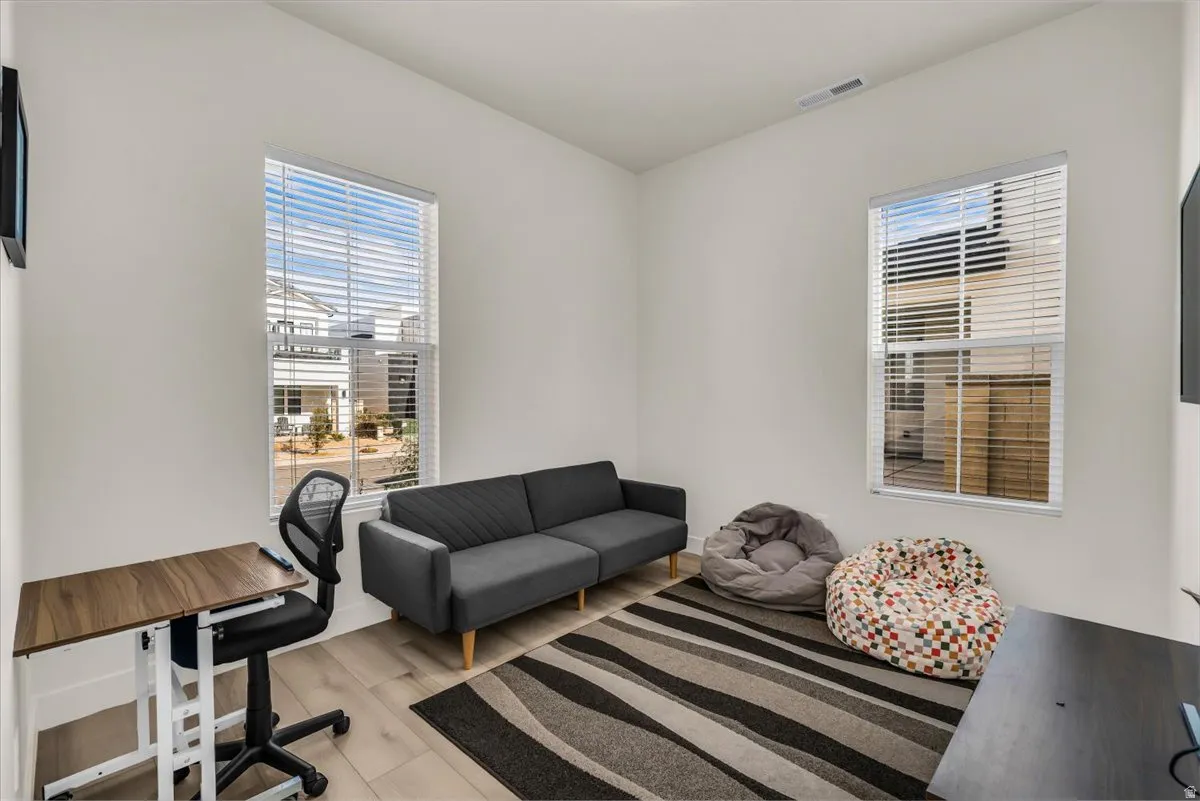 Office space with light wood-type flooring and healthy amount of natural light