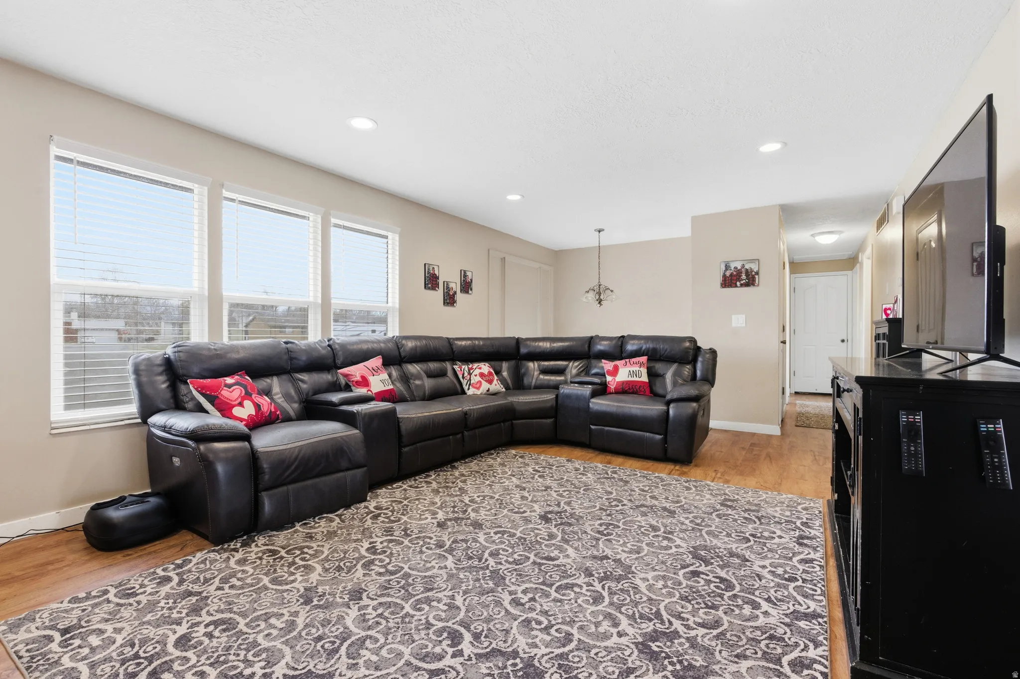 Living room with light wood-style floors and recessed lighting