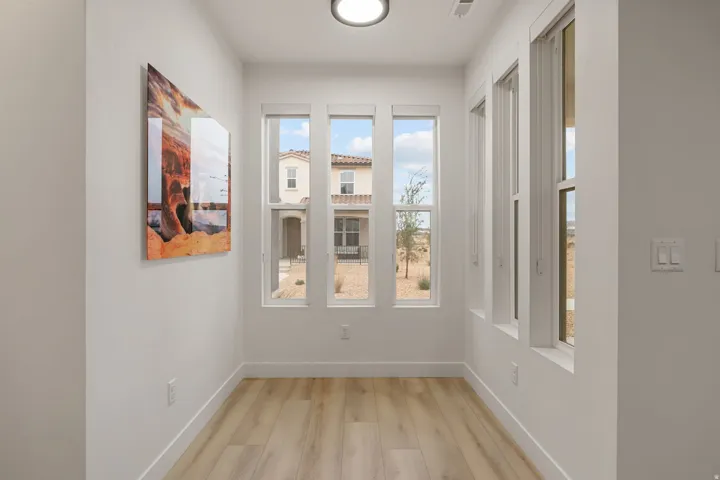 Unfurnished dining area featuring baseboards and wood finished floors