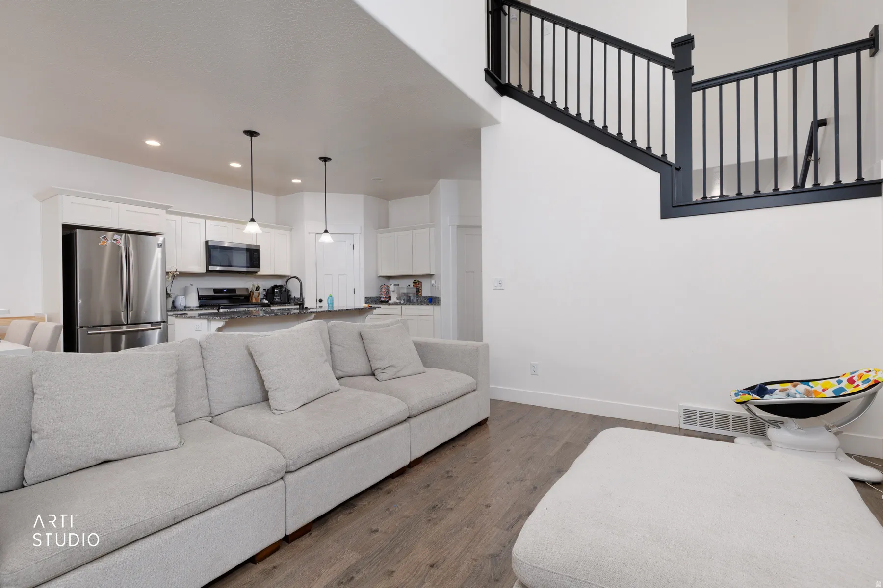 Living room featuring dark wood-type flooring and recessed lighting