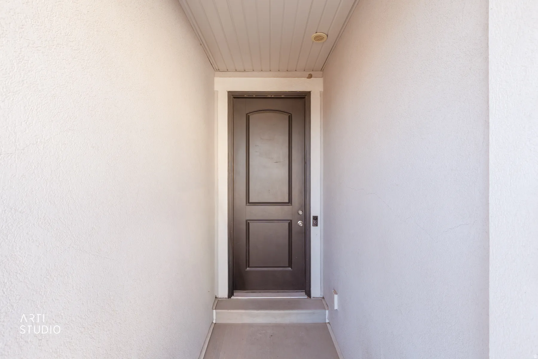 Entrance to property featuring stucco siding
