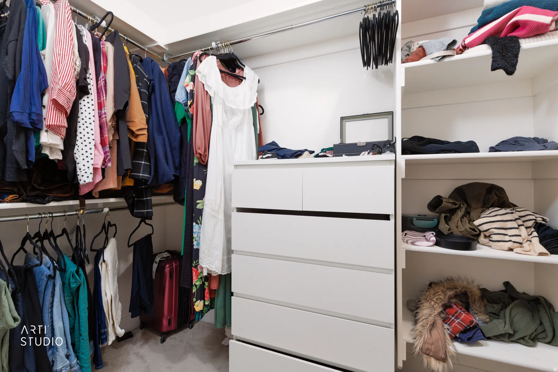 Walk in closet with light colored carpet