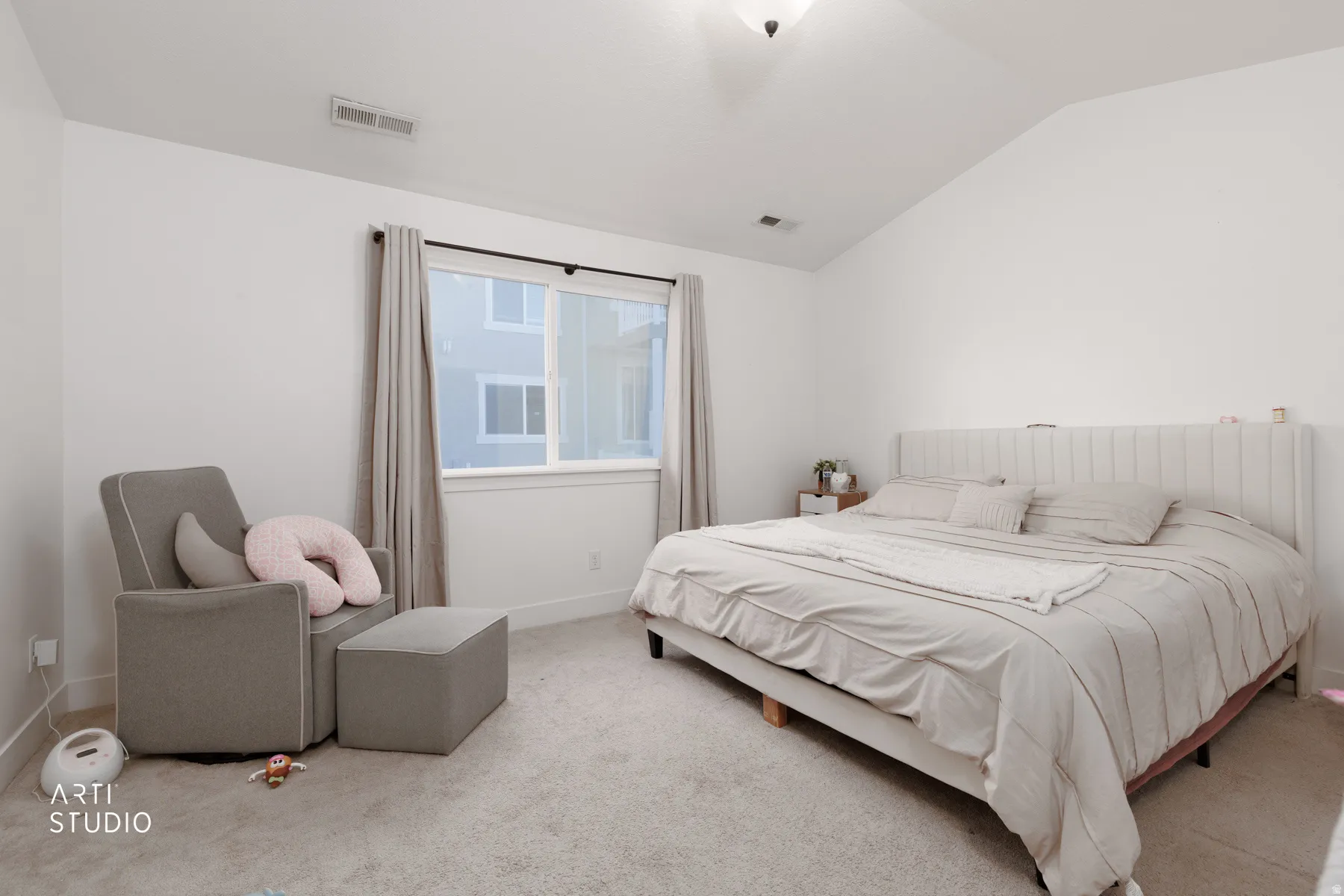 Bedroom featuring lofted ceiling and carpet flooring