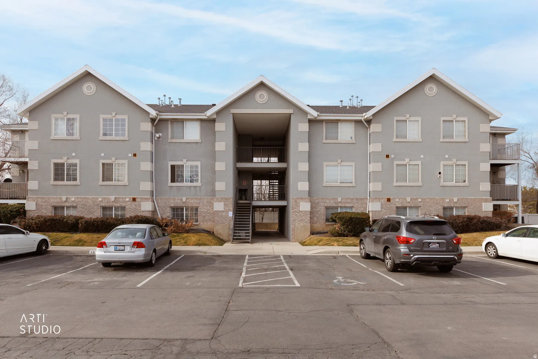 View of property featuring uncovered parking