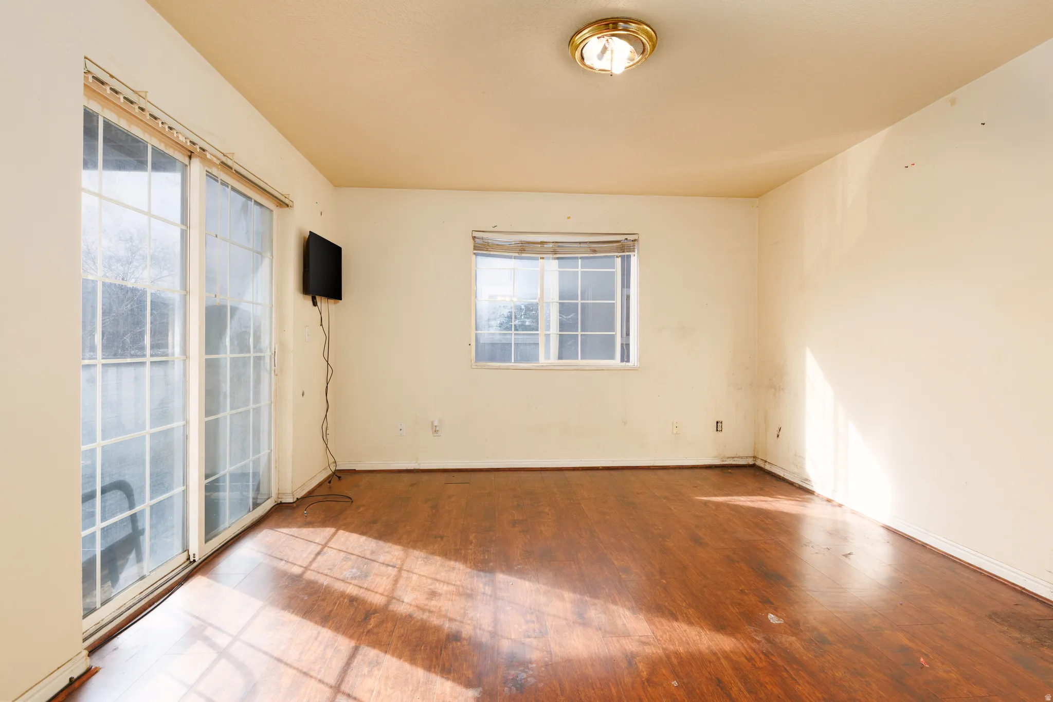 Empty room with wood finished floors and baseboards